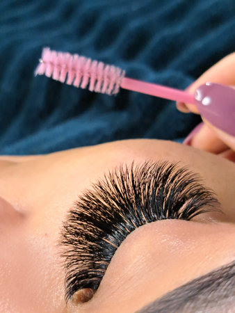 Close up of female eye with eyelash extensions,eyelash extension Procedure.,2d volume, 3d volume,...