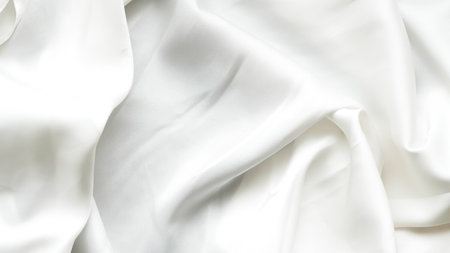 Soft white silk with natural crumples and elegant texture for backgrounds.の写真素材