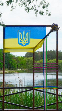 National flag of Ukraine in sunny park symbolizing peace and remembranceの写真素材