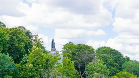 Famous statue of Saint Vladimir overlooking greenery and old Kyiv viewsの写真素材