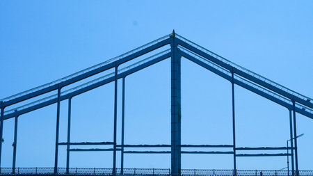 Low angle profile of pedestrian bridge showing minimalist steel frame architecture.の写真素材