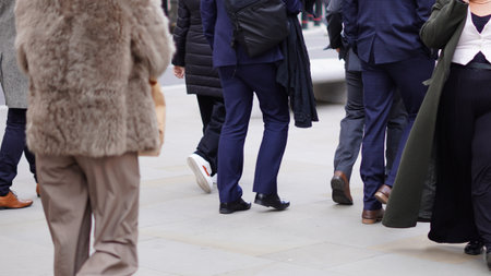 People walking down the street, city bustle, everyday motion.の写真素材