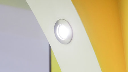 Warm recessed lights built into ceiling in soft interior setting.の写真素材
