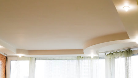 Modern recessed ceiling lighting setup in stylish kitchen interior.の写真素材