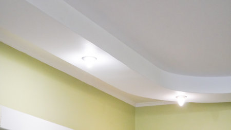 Modern recessed ceiling lighting setup in stylish kitchen interior.の写真素材
