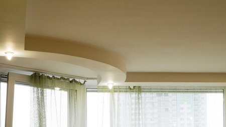 Minimal ceiling lights in modern interior with white walls and soft glow.の写真素材