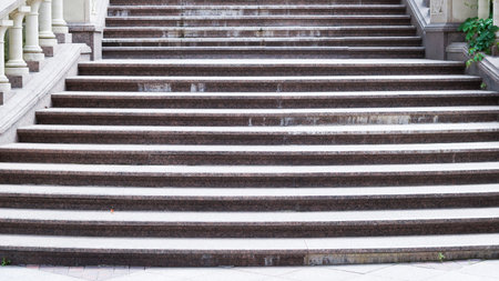 Elegant stone staircase with classical balustrade in urban park setting.