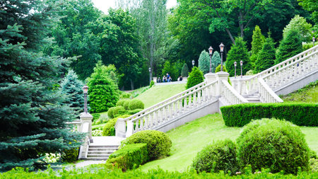 Classical stone staircase leads into lush green park environment.の写真素材
