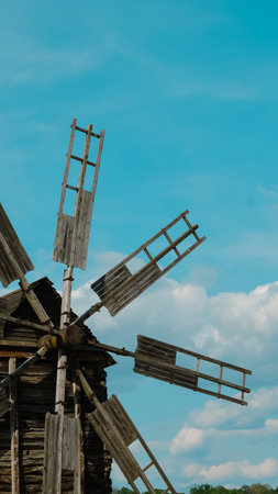 Historic windmill close view showing gear, wood and mechanical details.
