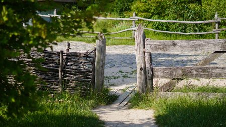Authentic Ukrainian whitewashed hut with thatched roof and wooden fence.の写真素材