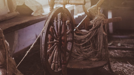 Traditional wooden wheel for weaving used in rural crafts and old-fashioned textile making.の写真素材