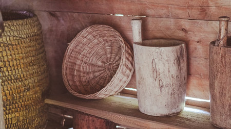 Rustic scene with carved wooden bowl and handwoven straw basketsの写真素材