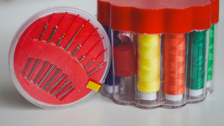 Thread spools in organizer with soft fabric on white background for sewing.の写真素材