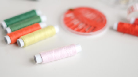Basic sewing tools with colorful threads and tape for beginner's workshop.の写真素材