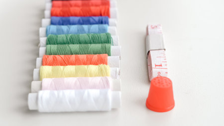 Basic sewing tools with colorful threads and tape for beginner's workshop.の写真素材