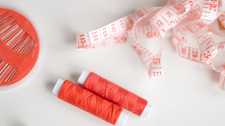 Basic sewing tools with colorful threads and tape for beginner's workshop.の写真素材