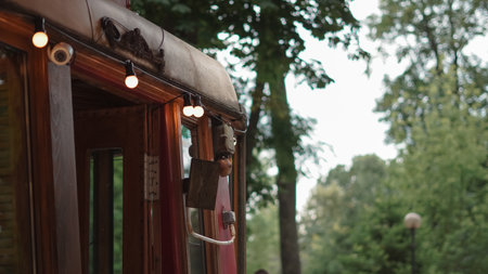 Cafe exterior with decorative light garlands creating a cozy street mood.の写真素材