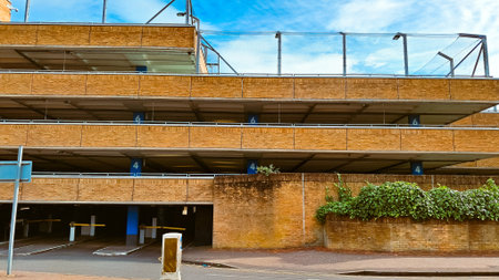 Urban facade texture with brick parking layers and blue sky as abstract background.の写真素材