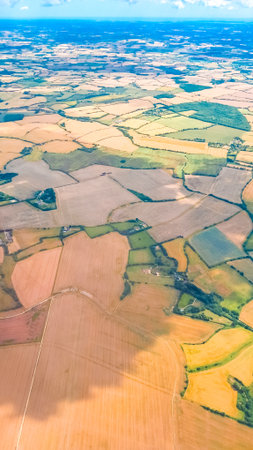 Aerial landscape with beautiful sky and airplane wing during high altitude flightの写真素材