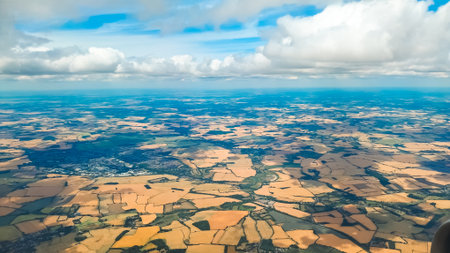 Aerial landscape with beautiful sky and airplane wing during high altitude flightの写真素材