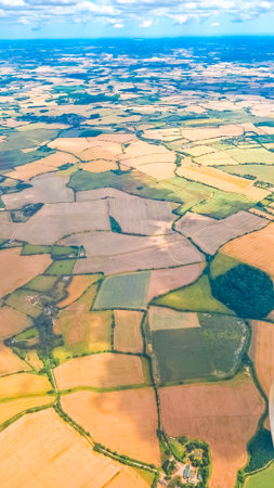 Aerial landscape with beautiful sky and airplane wing during high altitude flightの写真素材