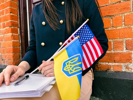 Woman with Ukraine and USA flags, symbol of support, war and second home.