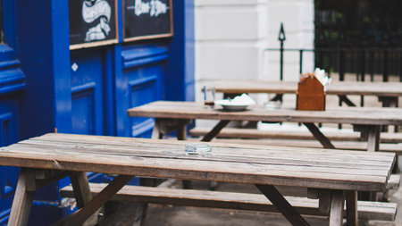 Cozy English pub with vintage design, dark wood furniture and blue interior wall.
