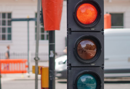 London traffic signal close to streetwork area with fences and safety barriers