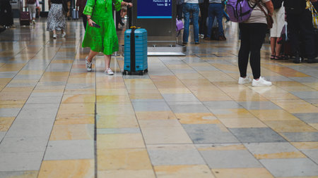 Transit moment at station with people carrying luggage during migration journey.
