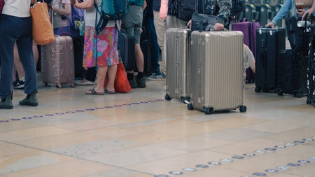 Low angle shot of walking people with travel bags at station in transit moment