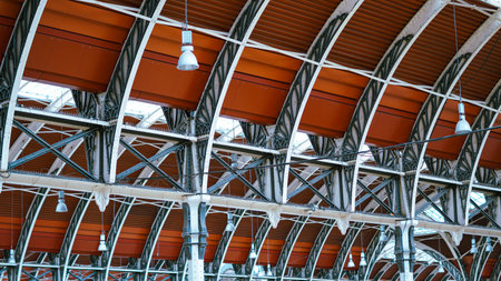 Historic London railway station roof with iron beams, cultural landmark.の写真素材