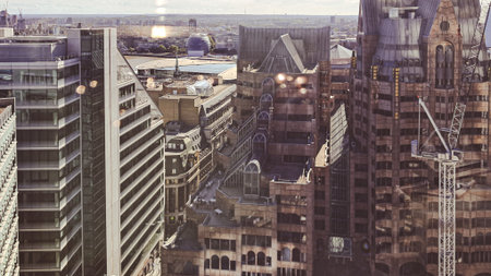 Urban skyline panorama with tall glass buildings under blue sky.の写真素材