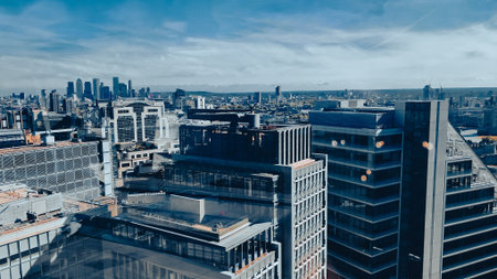 Aerial view of modern city skyline with tall skyscrapers in sunlight.の写真素材
