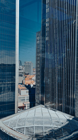 Aerial view of modern city skyline with tall skyscrapers in sunlight.の写真素材