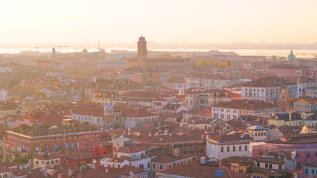 Aerial sunset view over Venetian rooftops and canals in soft glowの写真素材