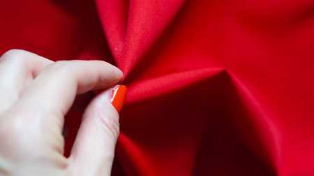 Red festive textile surface glowing gently in classic moodの写真素材