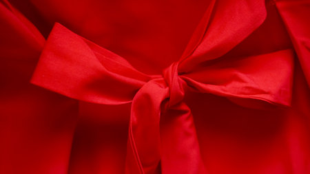 Gentle folds of red fabric forming atmospheric Christmas color ambience.の写真素材