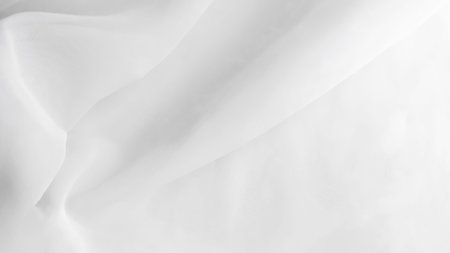 White fabric with soft folds and textures creating an elegant and smooth appearance
