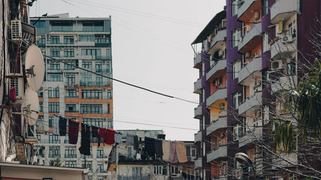 View of residential buildings with colorful facades and laundry hanging between them in an urban areaの写真素材