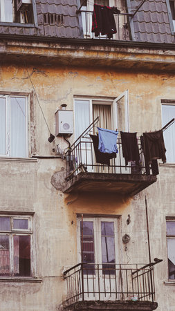 Balcony of an apartment building with clothes drying and an air conditioning unit mounted on the wallの写真素材