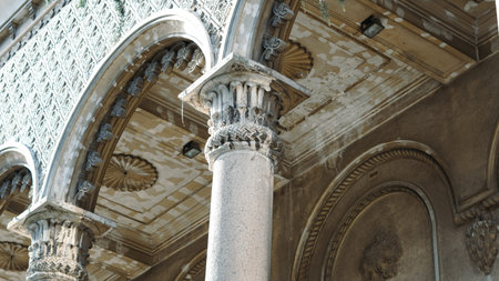 Close-up view of classical columns and intricate ceiling design in a historic structure