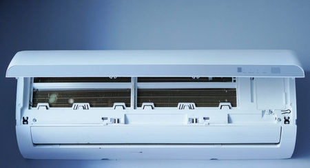 Air conditioning unit with open front cover showing internal components and filters