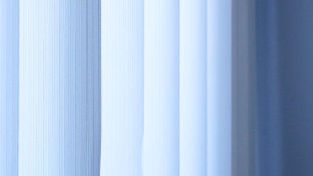 Light blue sheer curtains gently diffuse sunlight in a bright indoor environmentの写真素材