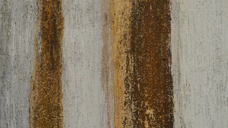 Close-up of an abstract wall featuring vertical stripes in earthy and neutral tones