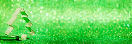 Christmas tree for cookies on a shiny green background. Bannerの写真素材