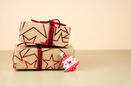 Gifts tied with a red ribbon on a pink background.