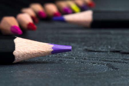Colored pencils on a gray wooden backgroundの写真素材