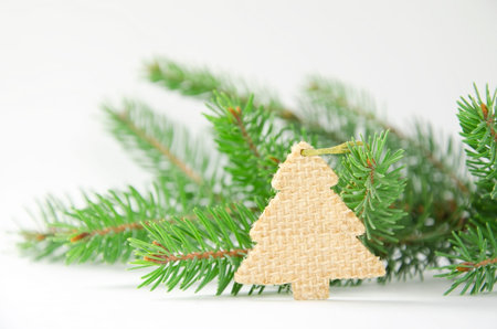 Wooden decoration on the background of a fir branch