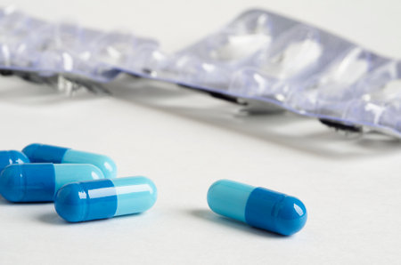 blue tablets lie on a white surfaceの写真素材