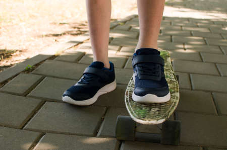 a boy in sneakers on a skateboardの写真素材